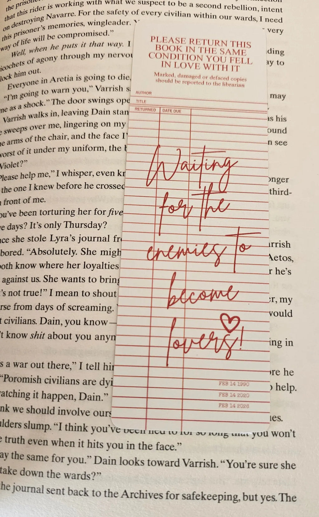 "Library card style romance bookmark reading 'Waiting for the Enemies to Become Lovers' on a romantasy book"