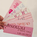 "Hand holding a fanned set of 7 pink romance bookmarks with bookish quotes and illustrations"