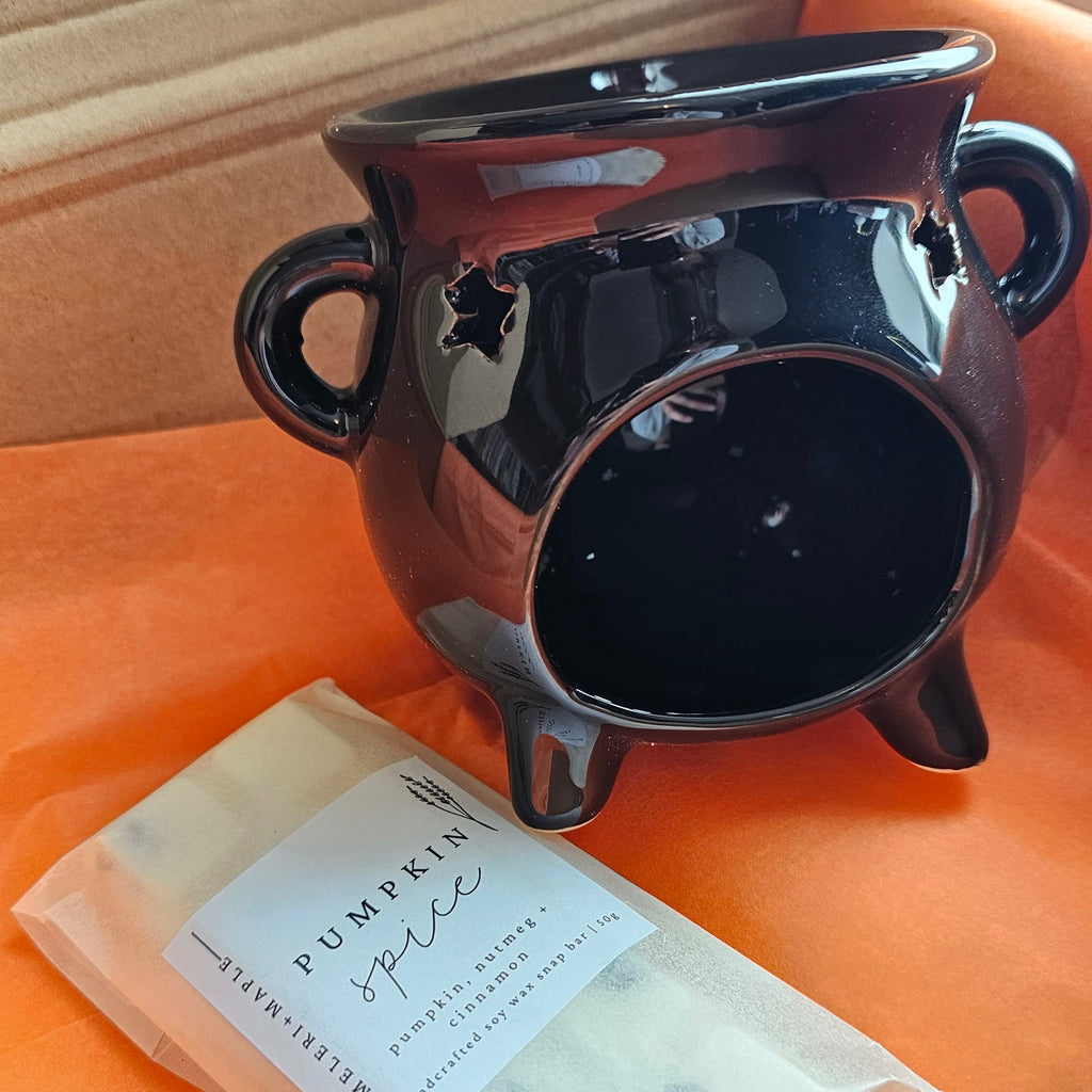 "Black ceramic witches cauldron wax melt burner with Pumpkin Spice handcrafted soy wax melt snap bar, included in the Spread Those Pages Halloween book box"